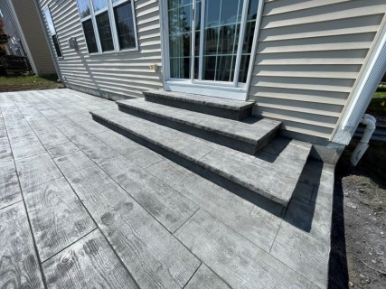 12-inch wood plank stamped concrete with Gull Gray integral, Charcoal release and wedding cake cantilever steps in Greenwood Indiana – Indy Decorative Concrete