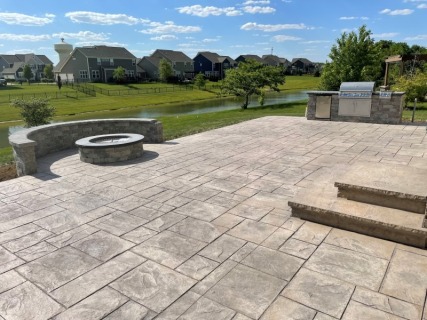 Majestic Ashlar Slate - Autumn Oak Integral - Storm Gray Release - Gray Block Fire Pit and Seat Wall with Dark Gray Top Cap - Large Built-In Grill with Dark Top Cap - Wedding Cake Cantilever Steps