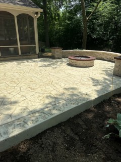 Appalachian Flagstone stamped concrete with Bone hardener, Arena Buff release, tooled border with no color change, seat wall, wood-burning fire pit and columns with custom top caps in Fishers Indiana – Indy Decorative Concrete
