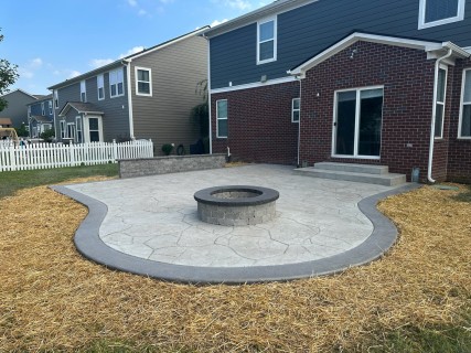 Appalachian Flagstone stamped concrete with Pewter integral, Smoke release, Storm Gray hardener border, wood-burning fire pit and rubbed steps in Noblesville Indiana – Indy Decorative Concrete
