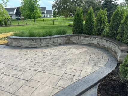 English Rivenstone stamped concrete with Autumn Oak integral, Storm Gray release, Storm Gray hardener border and seat wall in Carmel Indiana – Indy Decorative Concrete