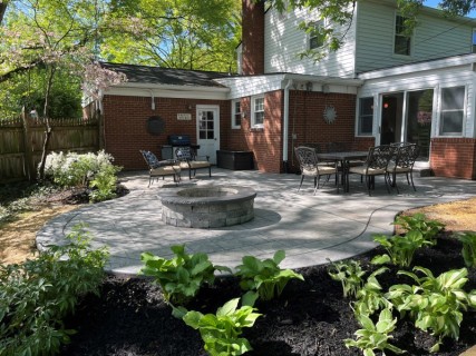 English Rivenstone stamped concrete with Pewter integral, Storm Gray release, Cape Cod Gray hardener border and wood-burning fire pit with custom cap in Indianapolis Indiana – Indy Decorative Concrete