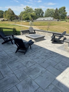 Majestic Ashlar Slate stamped concrete with Pewter integral, Charcoal release, Storm Gray hardener border and seat wall and smokeless fire pit with custom cap – Indy Decorative Concrete