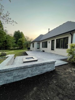 Majestic Ashlar Slate stamped concrete with Pewter integral, Charcoal release, Storm Gray hardener border, wood-burning fire pit, seat wall and custom top cap in Hamilton County Indiana – Indy Decorative Concrete