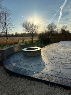 Orchard Stone stamped concrete with Pewter integral, Charcoal release, Storm Gray hardener border and wood-burning fire pit in Fishers Indiana – Indy Decorative Concrete