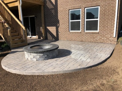 Verona Cobblestone stamped concrete with Autumn Oak integral, Storm Gray release and wood-burning fire pit with custom top cap in Zionsville Indiana – Indy Decorative Concrete