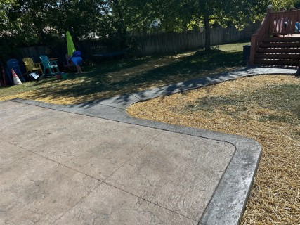 Hadley Creek stamped concrete in Mocha Brown with Charcoal release and Storm Gray hardener border