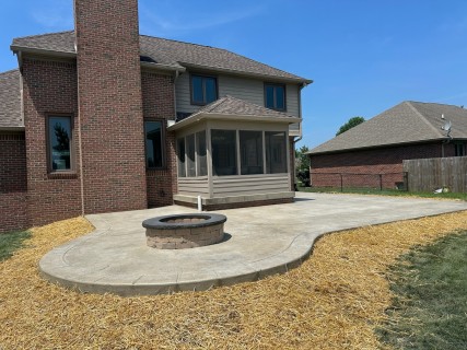 Heavy Stone stamped concrete with Lanon Stone integral color, Storm Gray release, tooled and scored border, and wedding cake cantilever steps in Greenwood Indiana – Indy Decorative Concrete