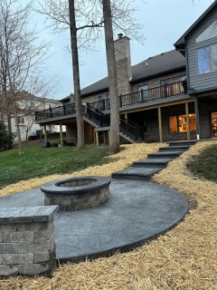 Oxford Slate stamped concrete with Gull Gray integral, Charcoal release, gray block seat wall and fire pit with dark gray top cap and cantilever steps in New Pal Indiana – Indy Decorative Concrete