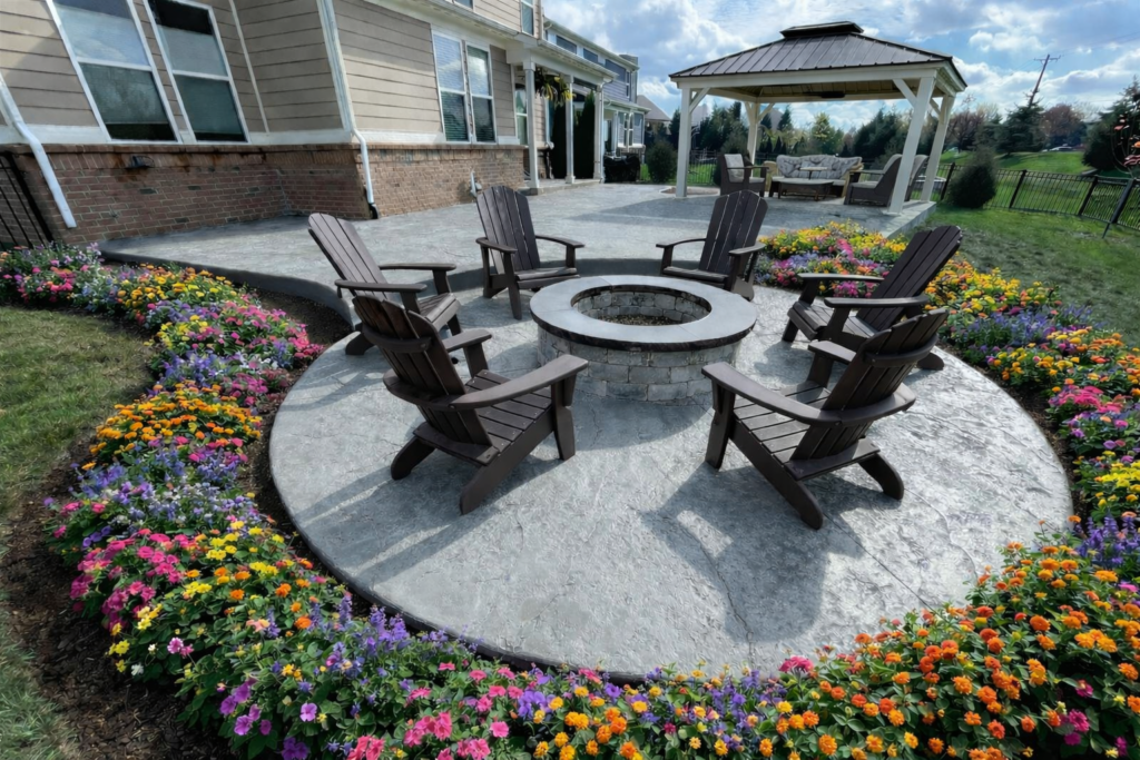 Stamped concrete patio with heavy stone texture, pewter integral color, and storm gray release with fire pit in Indianapolis area